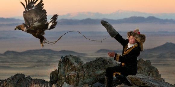 13 year old Ashol Pan with her eagle - Despite her young age, Ashol had the amazing ability to control and be able to caress her eagle, almost as if she had been with it for years. (Asher Svidensky/Caters News)
